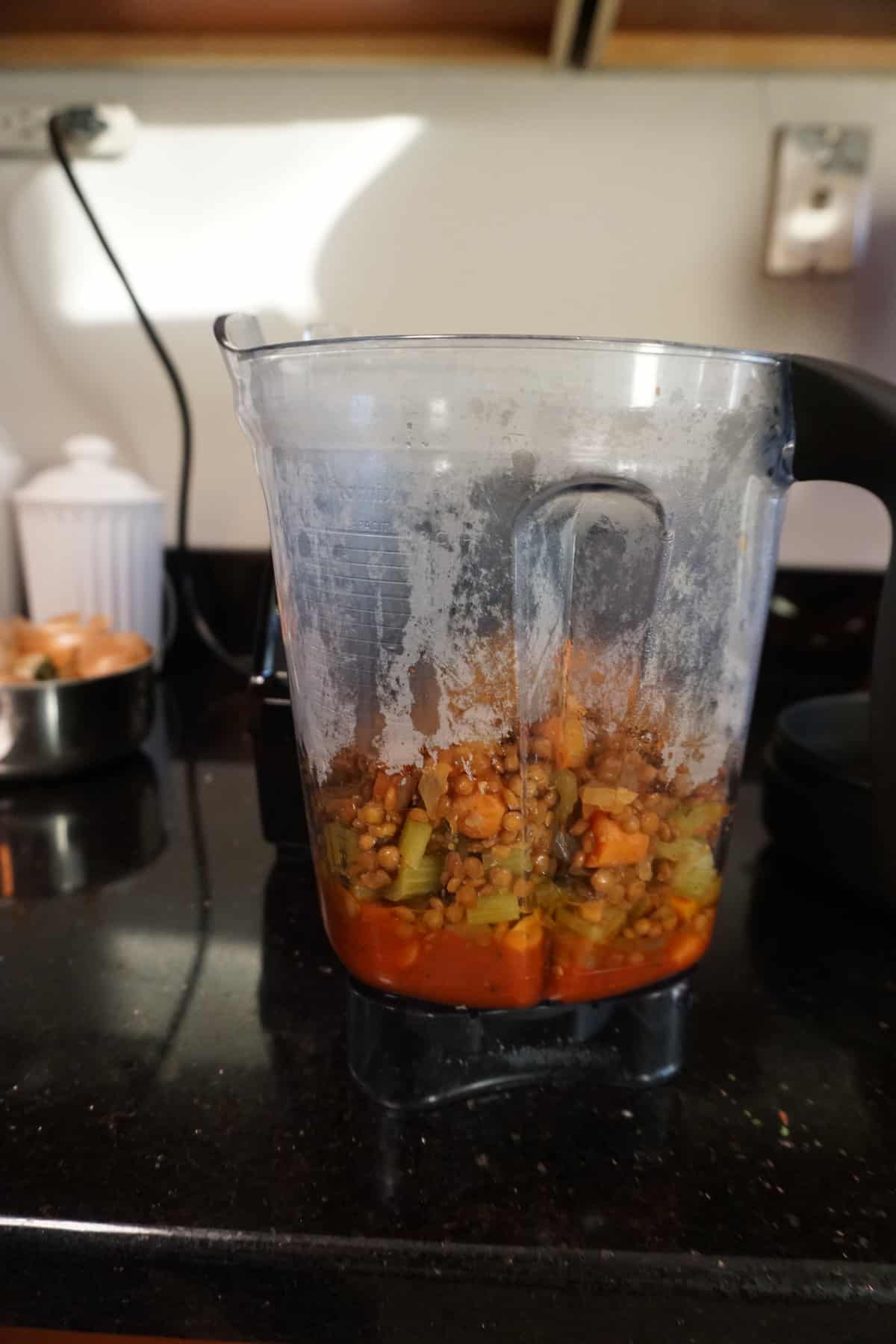 add your cooked lentils and tomato sauce into a blender for tomtao and lentil soup 