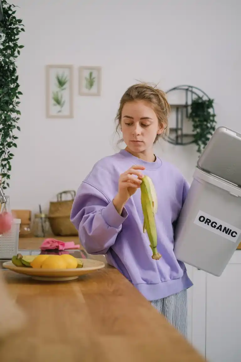 woman standing on a counter holding a banana peel