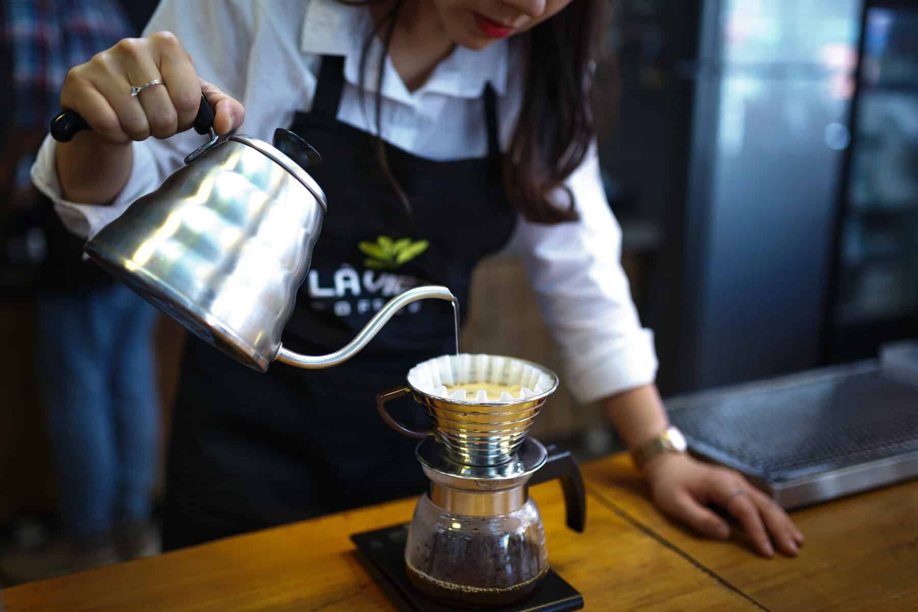 woman pouring coffee in cup