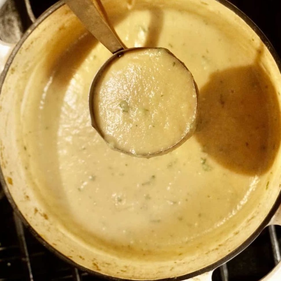 vegetarian or vegan potato leek soup in a ladel