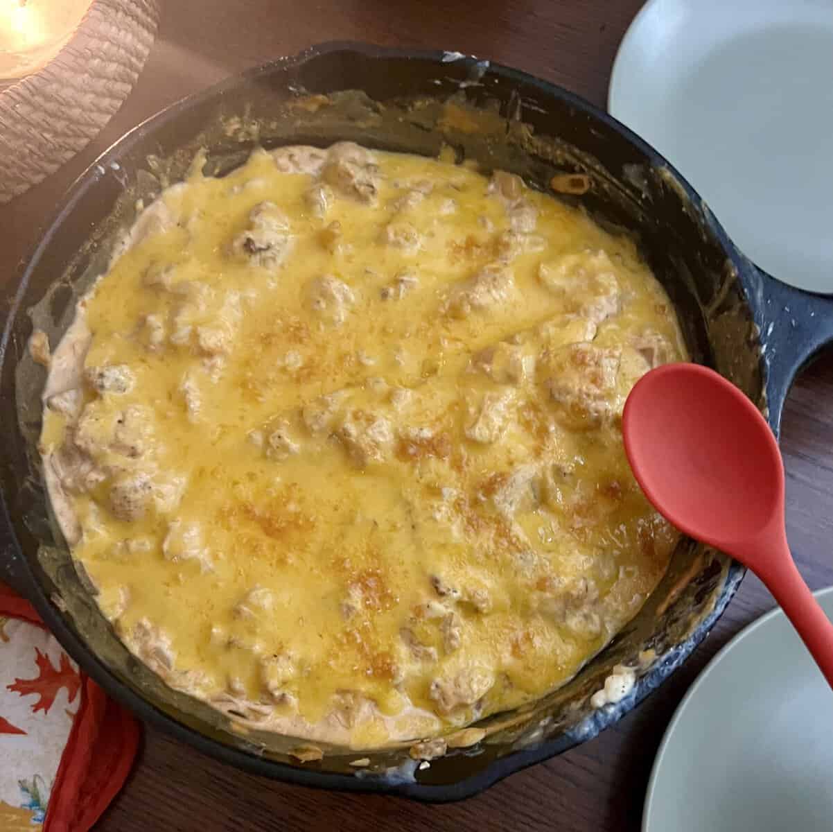 cheesy dip with cauliflower covered in cheese