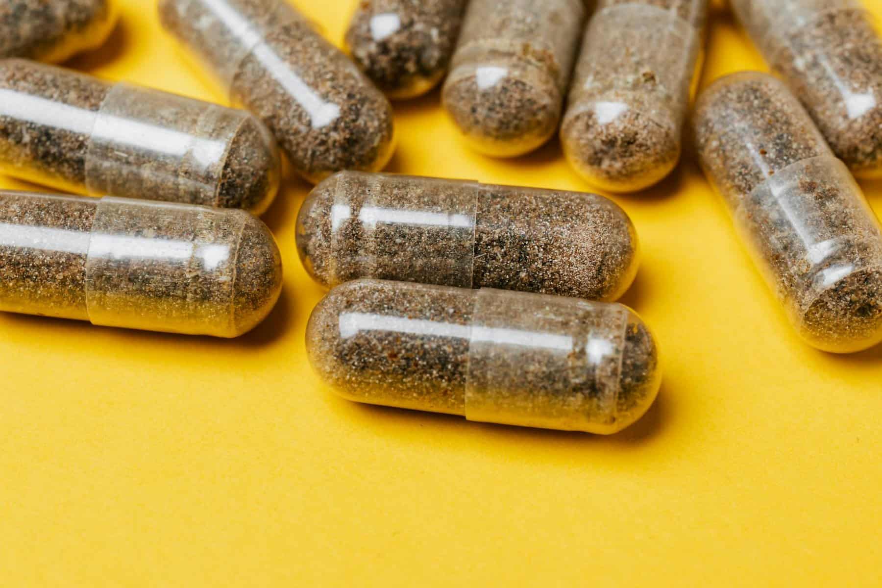 vegetarian capsules on yellow surface made from hpmc