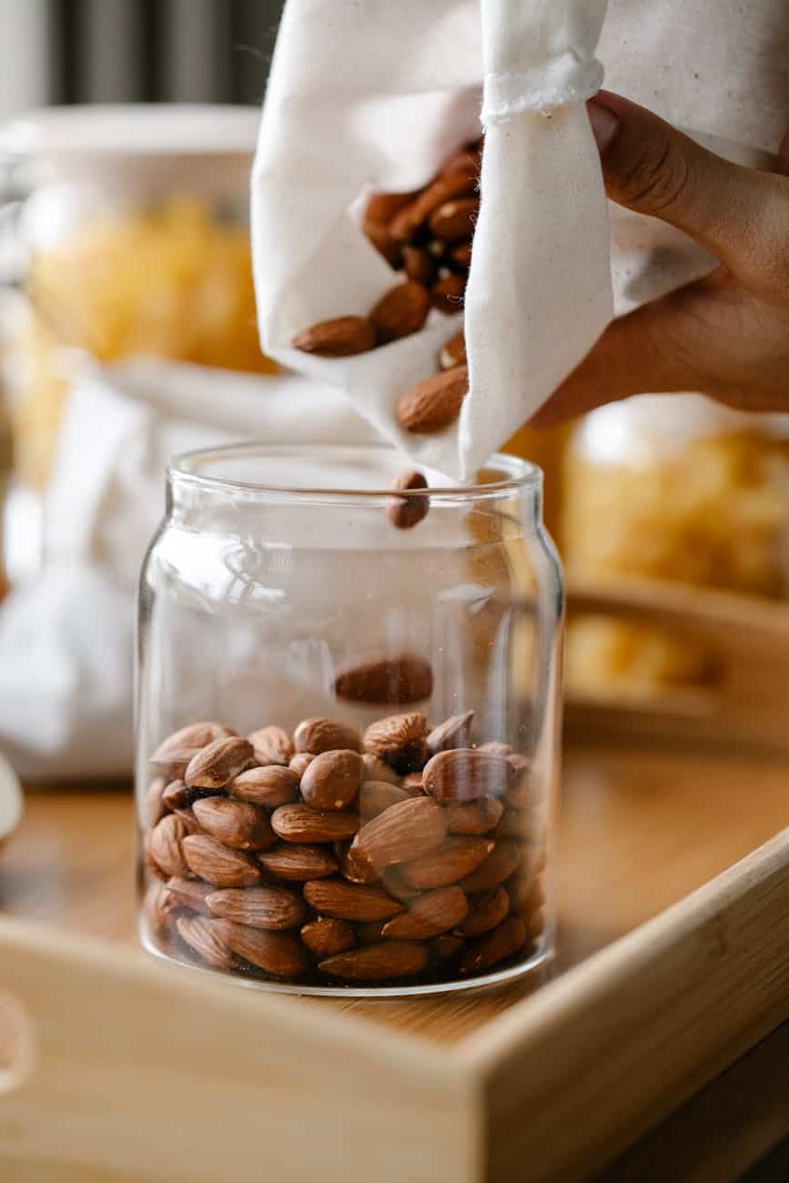 anonymous person pouring out almonds from eco friendly bag