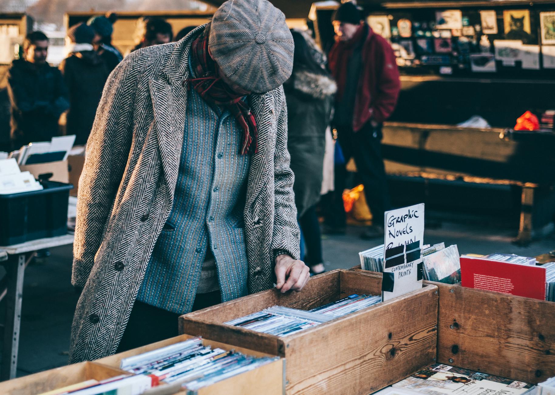 person standing in front of brown crate thrifting and helping the environment