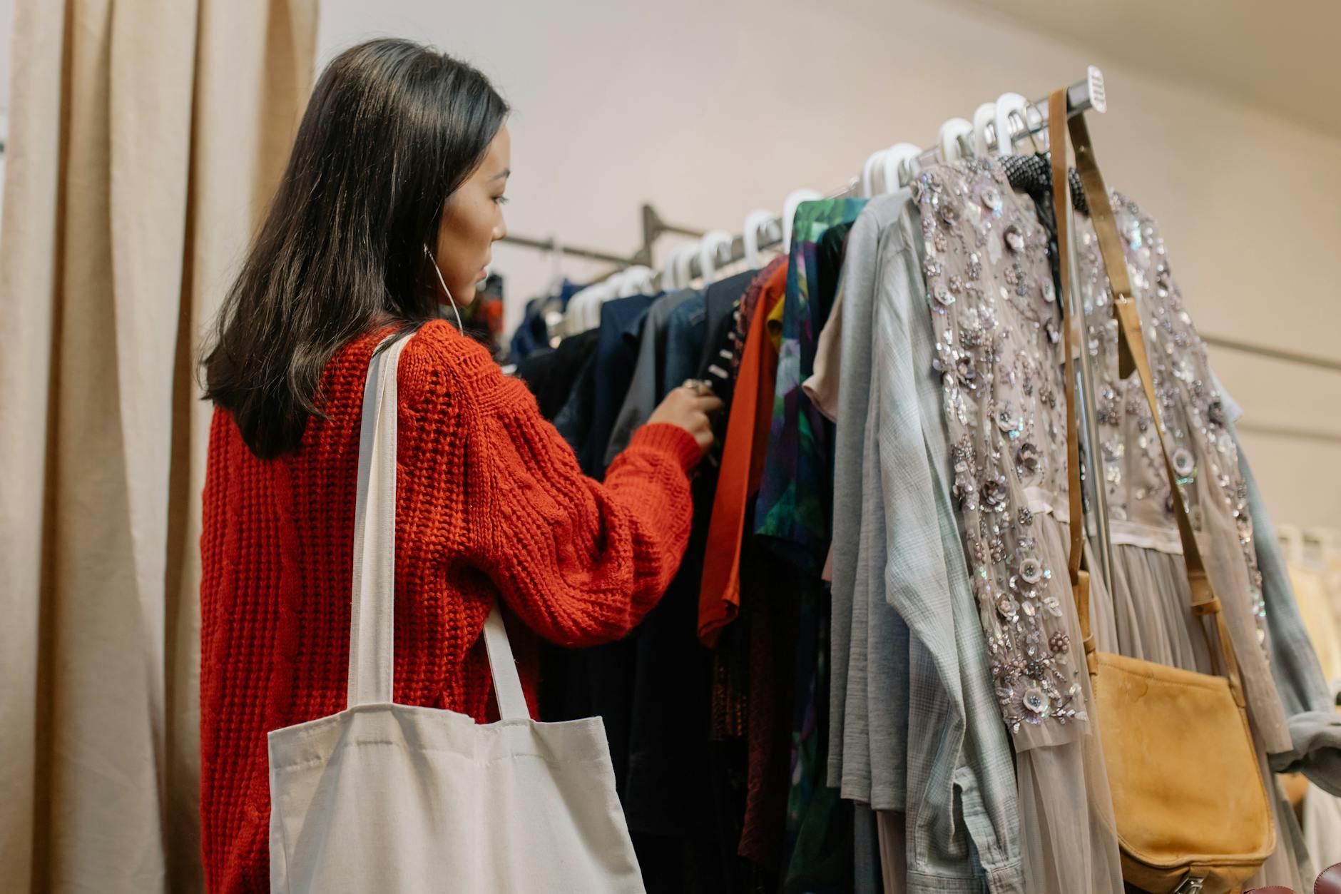 a woman shopping for clothes in a thrift store