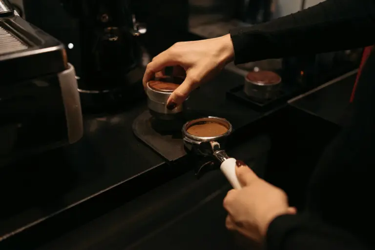close up shot of a person brewing coffee