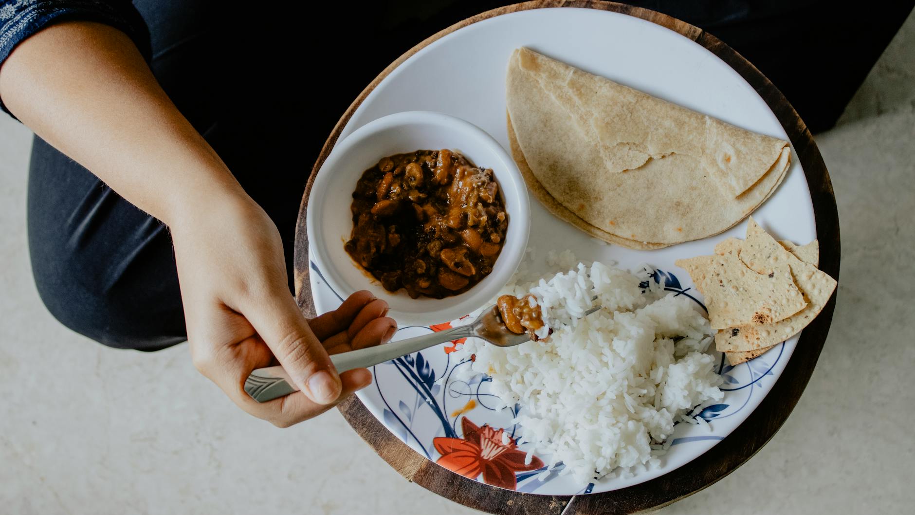 person using fork while eating