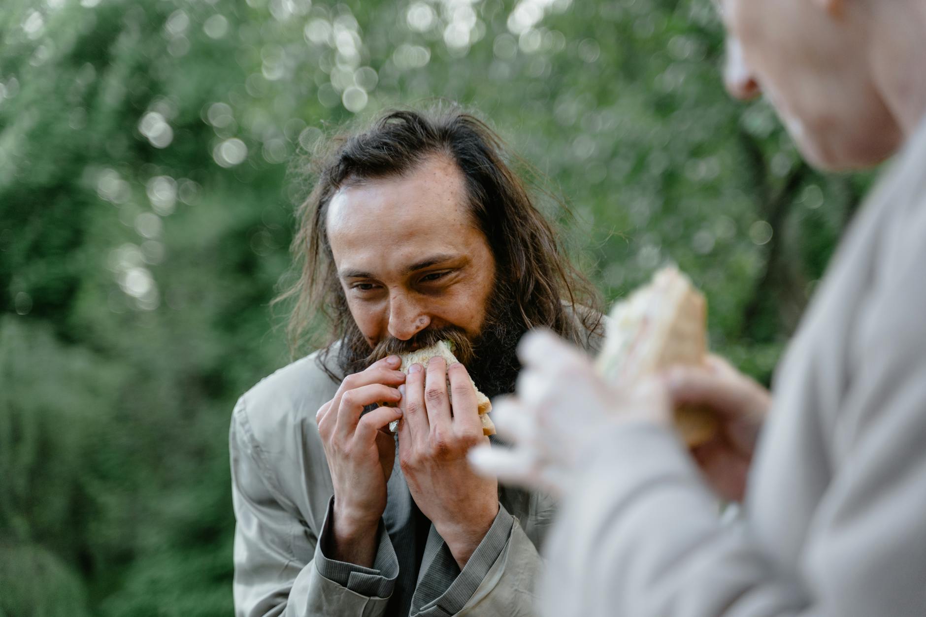 homeless man eating sandwich highlights food insecurity