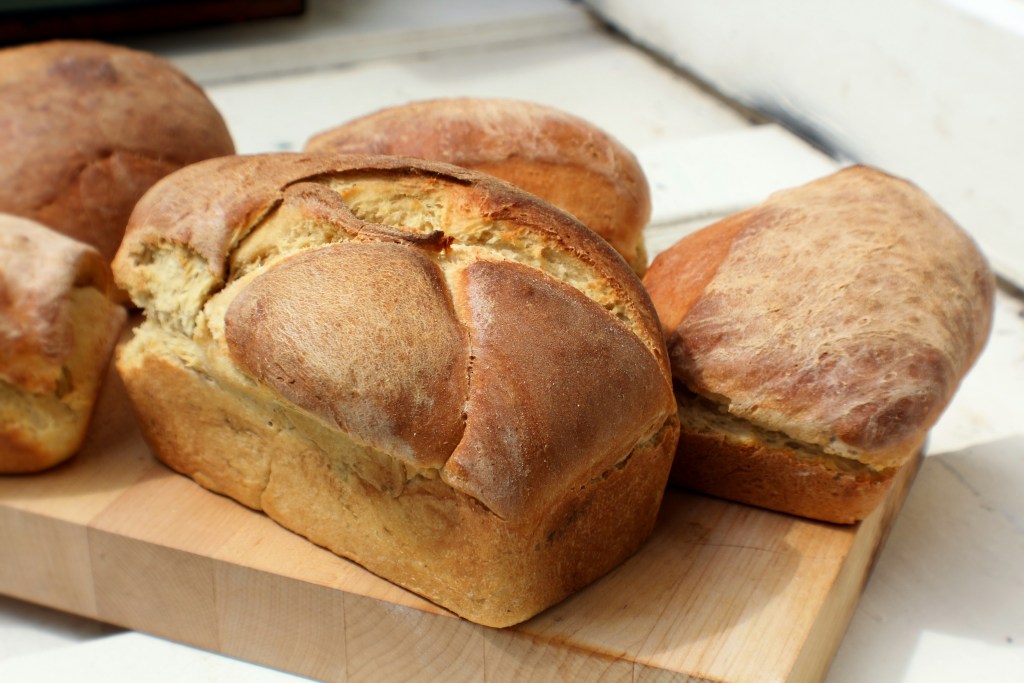 loaves of bread on a cutting board 