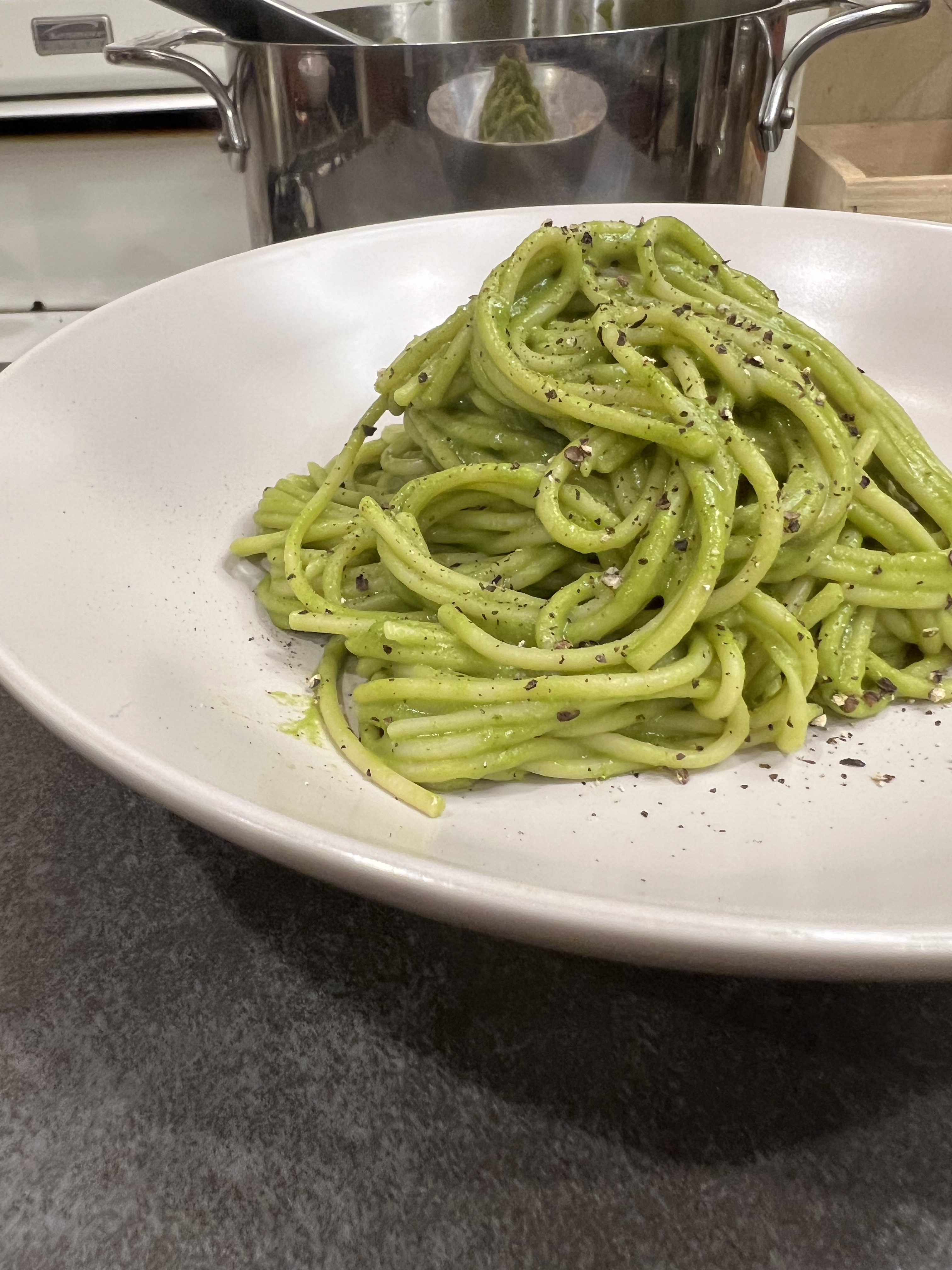 spinach pesto pasta recipe on a plate is vibrant green