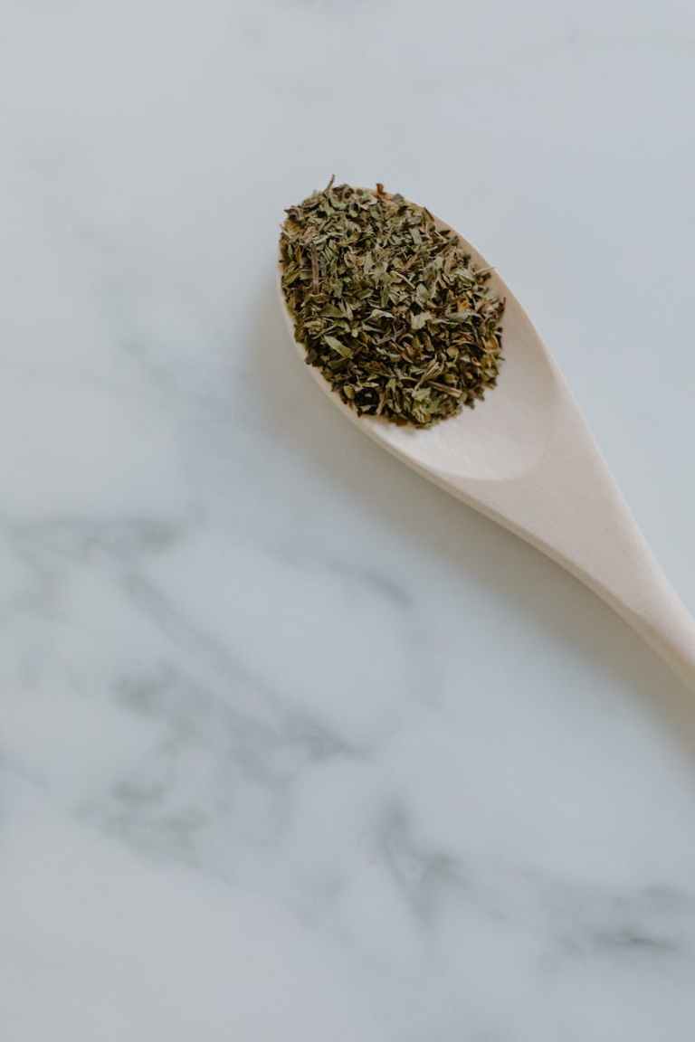 dried herb on a wooden spoon