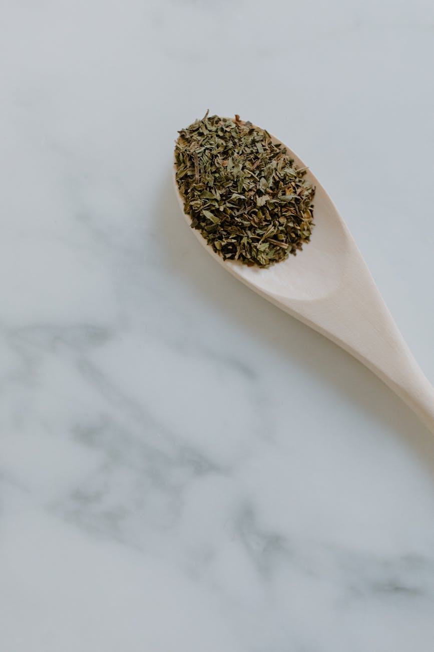 dried herb on a wooden spoon