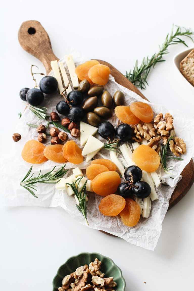 various nuts and fruits on a cutting board
