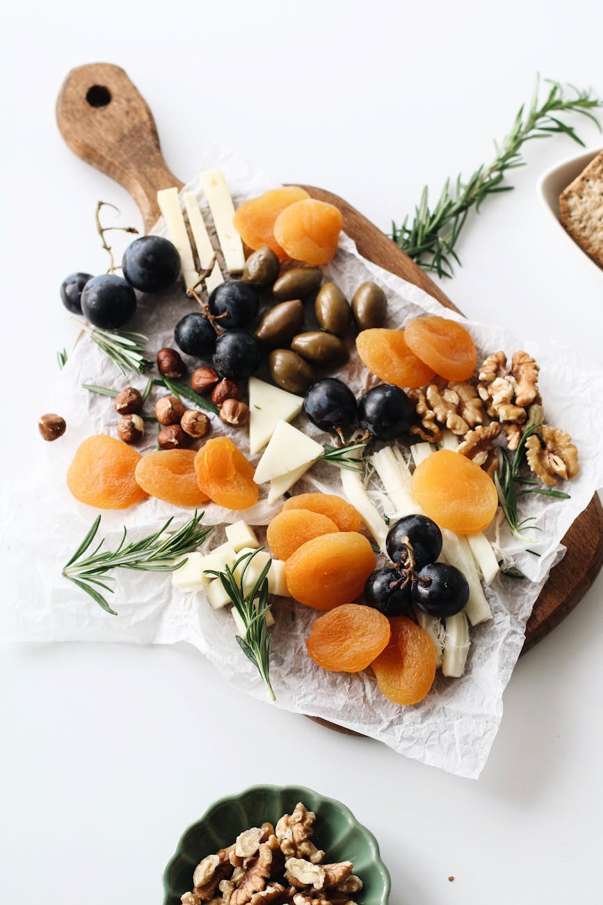 various nuts and fruits on a cutting board