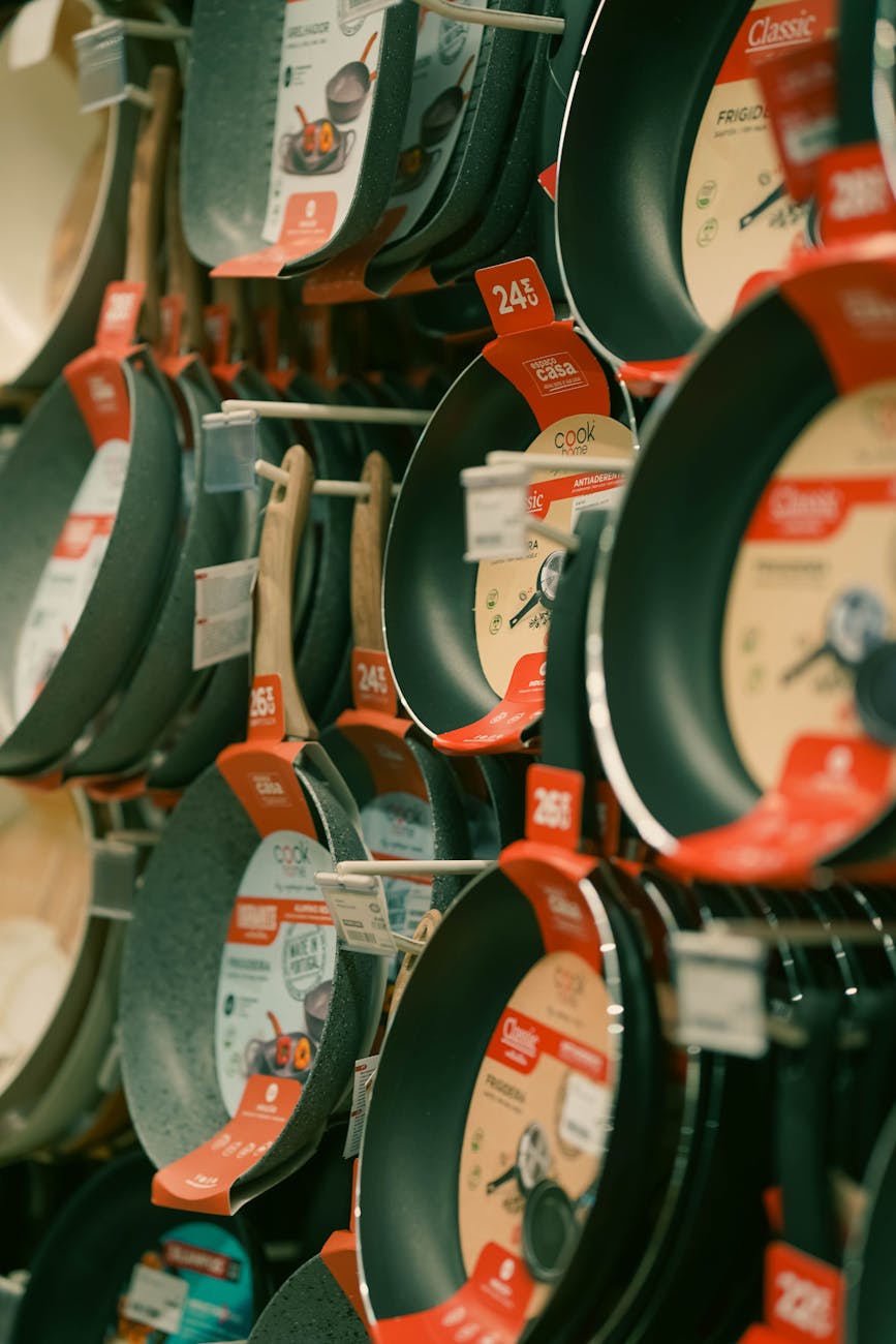 variety of non stick frying pans on store display contain teflon and PFAs