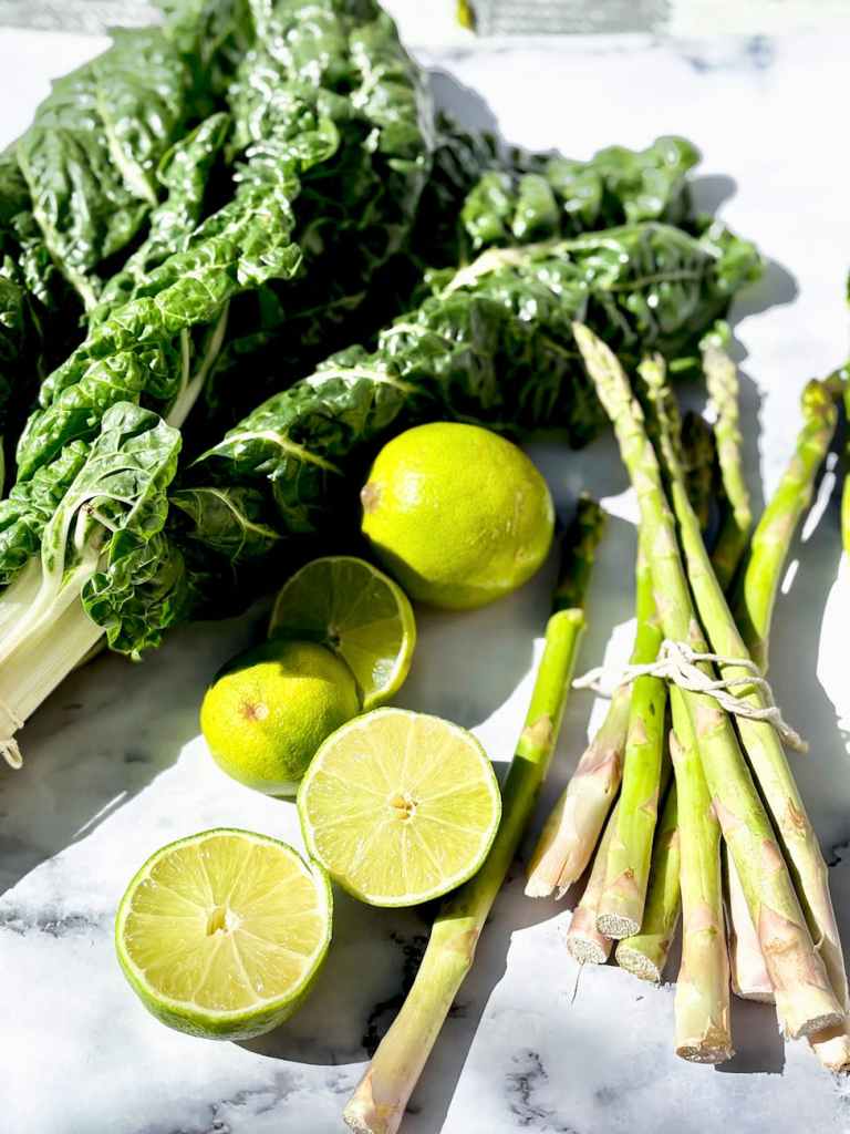 fresh green vegetables and limes on marble