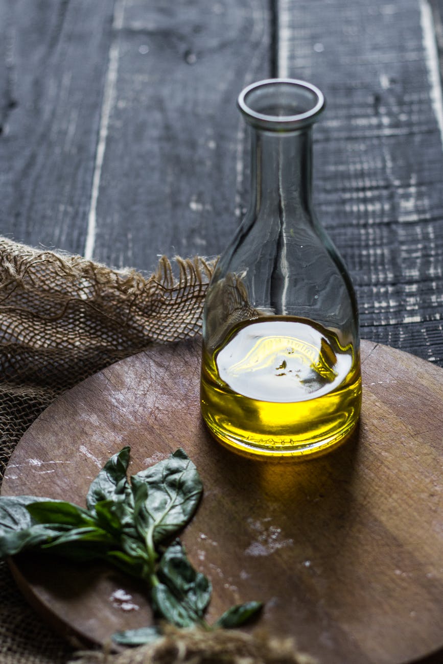 olive oil in a glass bottle on a cutting board